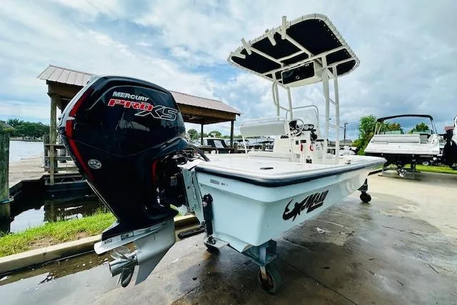 Slide: The Image of 2023 Mako 18 LTS boat with Mercury Pro XS engine, docked outdoors. - 4