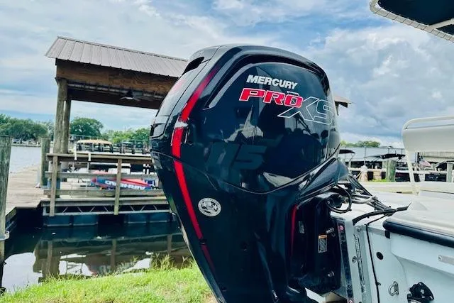 Slide: The Image of 2023 Mako 18 LTS boat with Mercury Pro XS engine at a dock. - 5