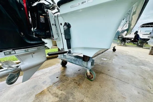 Slide: The Image of 2023 Mako 18 LTS boat on a wheeled stand, showcasing the motor and hull. - 6