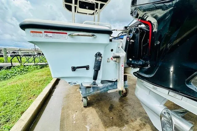 Slide: The Image of 2023 Mako 18 LTS boat transom with motor mount, docked on a cloudy day. - 7