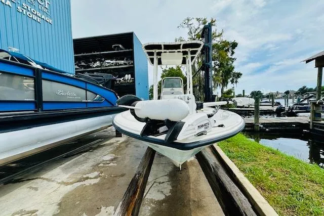 Slide: The Image of 2023 Mako 18 LTS boat in marina storage, front view, blue and white design. - 9