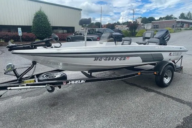 Slide: The Image of 1996 Javelin 369SE boat on trailer, parked outdoors, with visible registration number. - 3