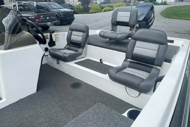 Slide: The Image of 1996 Javelin 369SE boat interior with gray seating and steering wheel. - 4