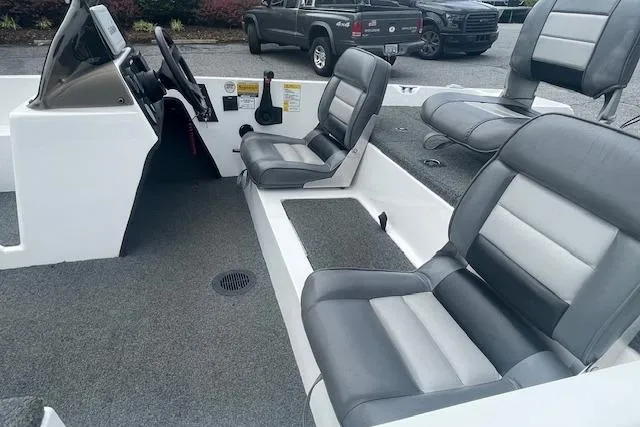 Slide: The Image of 1996 Javelin 369SE boat interior with gray seating and steering console. - 5