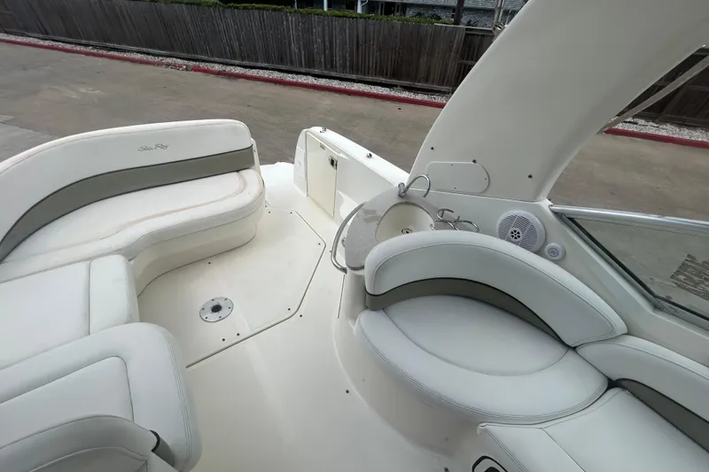 Slide: The Image of 2005 Sea Ray 260 Sundancer boat interior with white seating and built-in speaker. - 14