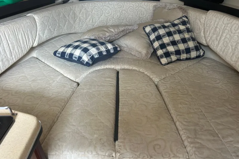 Slide: The Image of Interior cabin of 2005 Sea Ray 260 Sundancer with patterned cushions and pillows. - 15