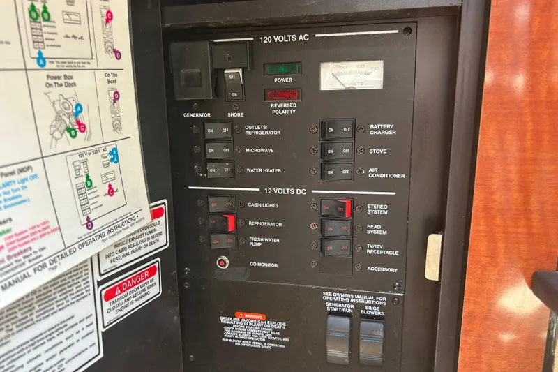 Slide: The Image of Control panel of a 2005 Sea Ray 260 Sundancer boat, showing electrical switches. - 19