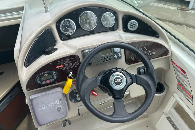 Slide: The Image of 2005 Sea Ray 260 Sundancer dashboard with steering wheel and control panel. - 20