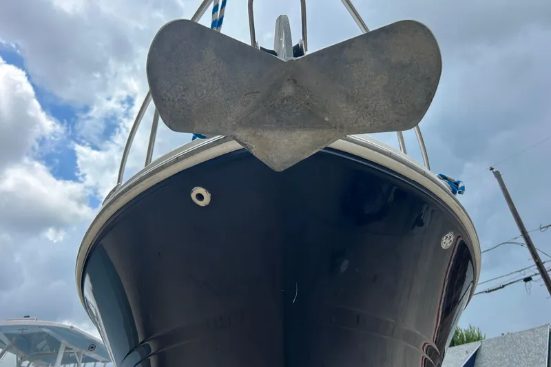 Slide: The Image of 2005 Sea Ray 260 Sundancer boat with anchor, viewed from below against cloudy sky. - 30
