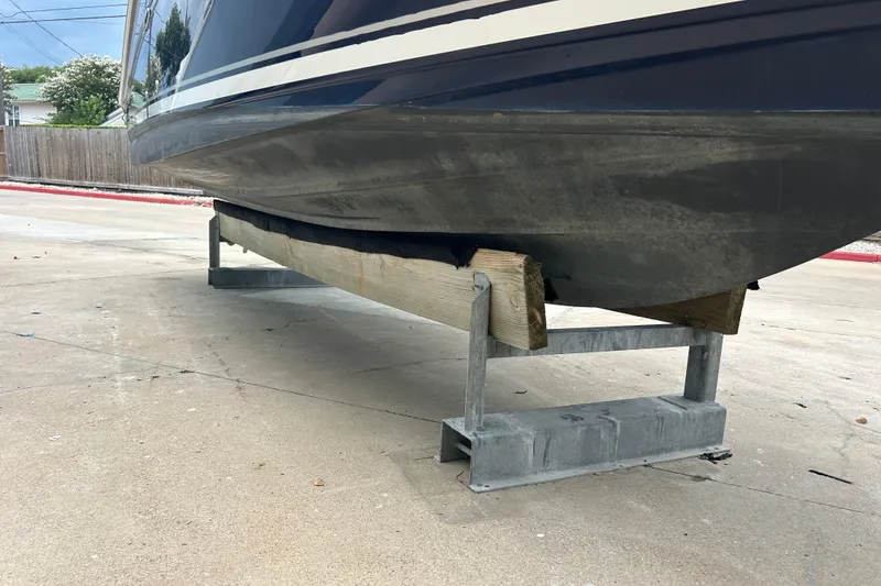 Slide: The Image of 2005 Sea Ray 260 Sundancer boat hull on a support stand, side view. - 32