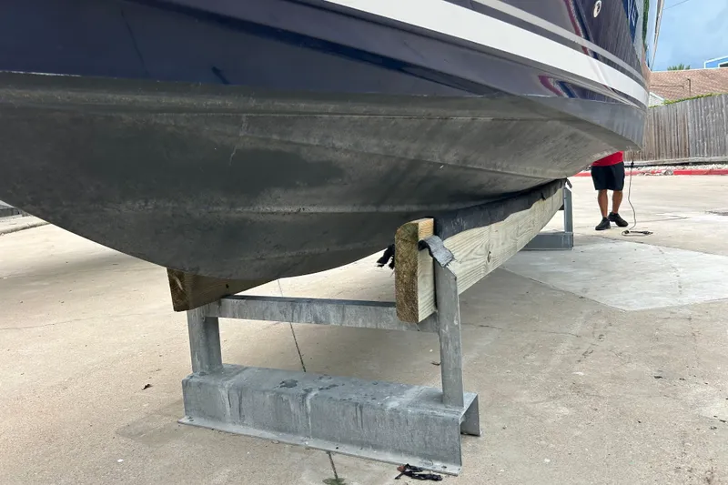 Slide: The Image of 2005 Sea Ray 260 Sundancer boat on a stand, viewed from below. - 33