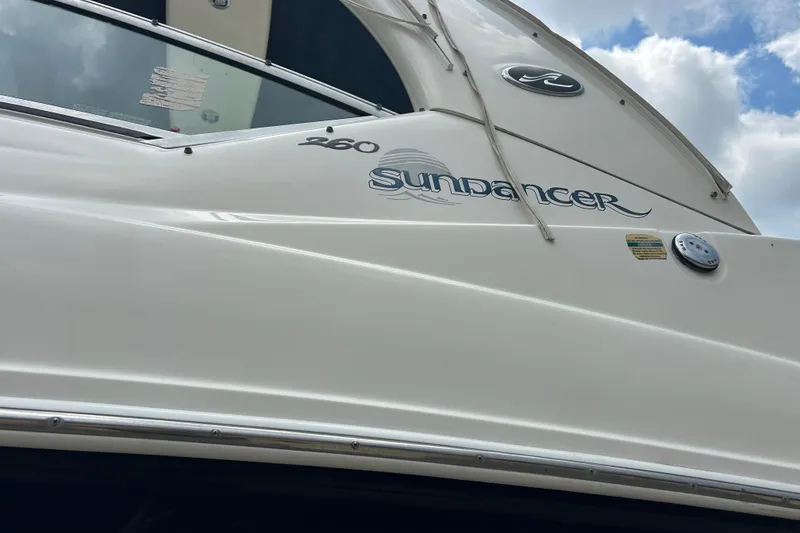 Slide: The Image of 2005 Sea Ray 260 Sundancer boat exterior with logo and sleek design. - 35