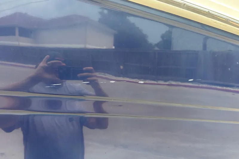 Slide: The Image of Reflection on the hull of a 2005 Sea Ray 260 Sundancer boat. - 36