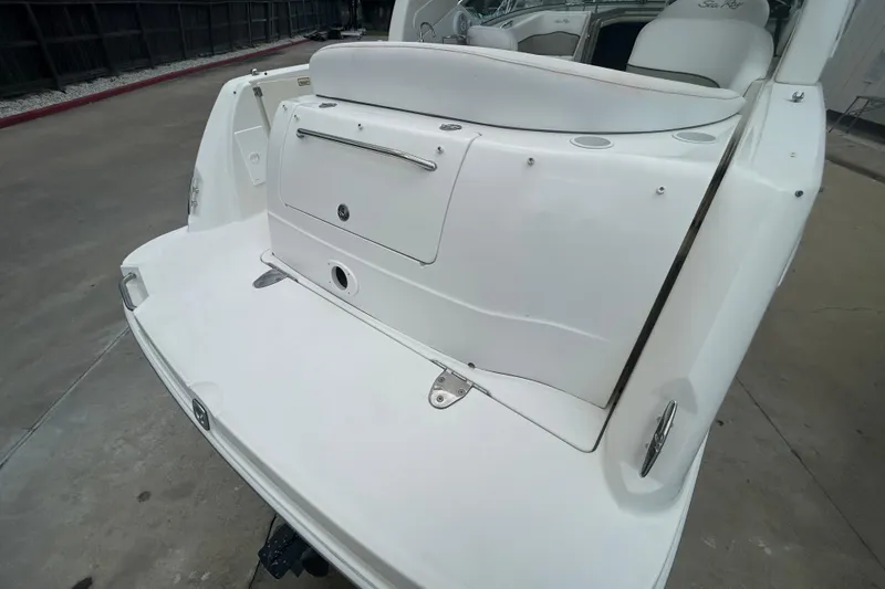 Slide: The Image of 2005 Sea Ray 260 Sundancer boat stern view with swim platform and storage compartment. - 7