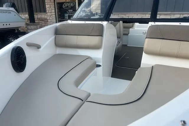 Slide: The Image of 2016 Bayliner 175 Bowrider interior with beige seating and speaker, showcasing comfort and style. - 3