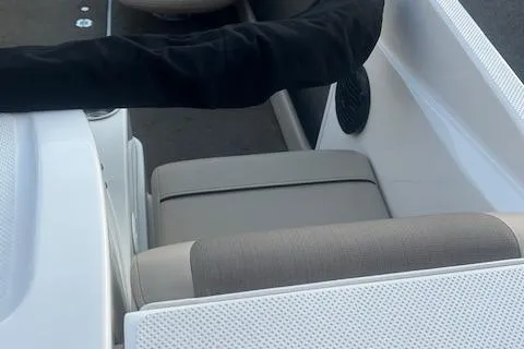 Slide: The Image of 2016 Bayliner 175 Bowrider interior seating with gray upholstery and black speaker. - 9