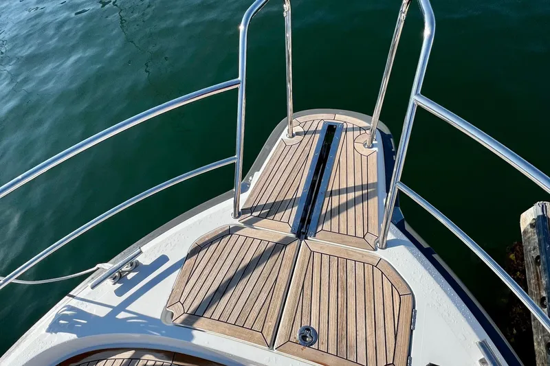 Slide: The Image of Bow view of 2018 Nimbus 365 Coupe with teak decking and stainless steel railings. - 25