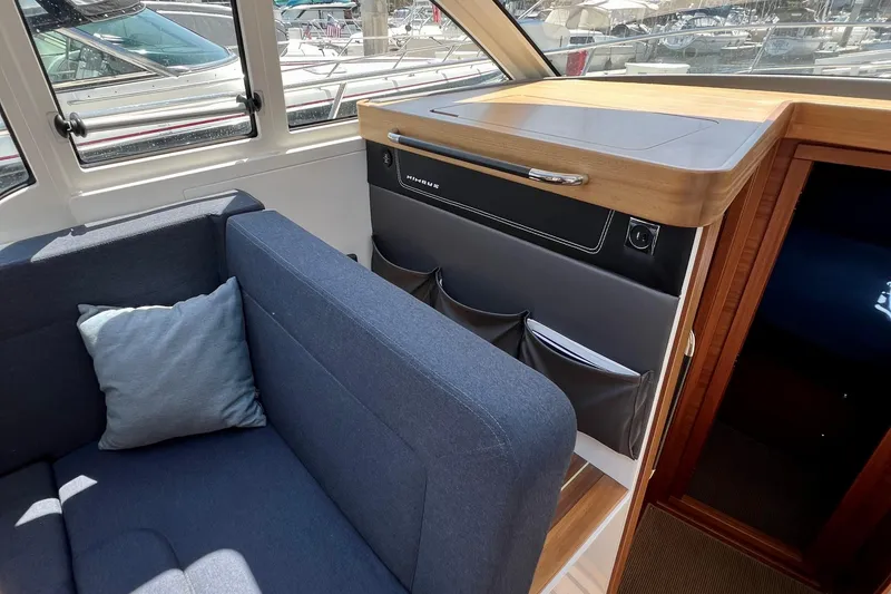 Slide: The Image of Interior of 2018 Nimbus 365 Coupe with blue sofa and wooden cabinetry. - 80