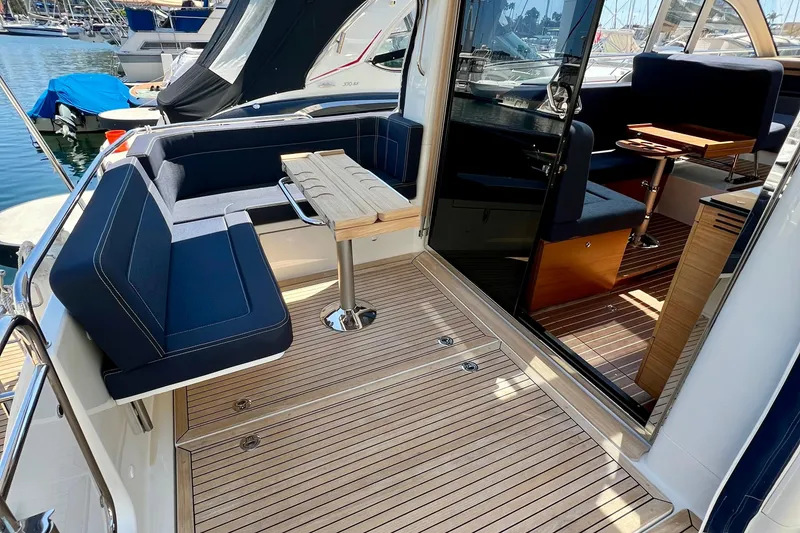 Slide: The Image of 2018 Nimbus 365 Coupe yacht interior with sleek seating and wooden flooring. - 40