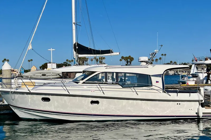 Slide: The Image of 2018 Nimbus 365 Coupe yacht docked in sunny marina with clear blue sky. - 1