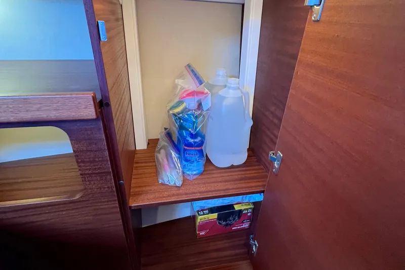 Slide: The Image of Storage cabinet in 2018 Nimbus 365 Coupe with cleaning supplies and water bottles. - 137