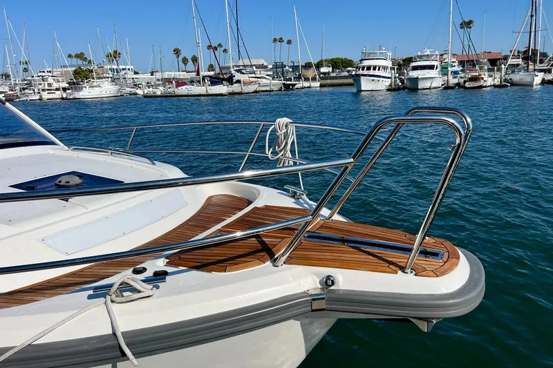 Slide: The Image of 2018 Nimbus 365 Coupe yacht docked in a marina with clear blue water. - 23