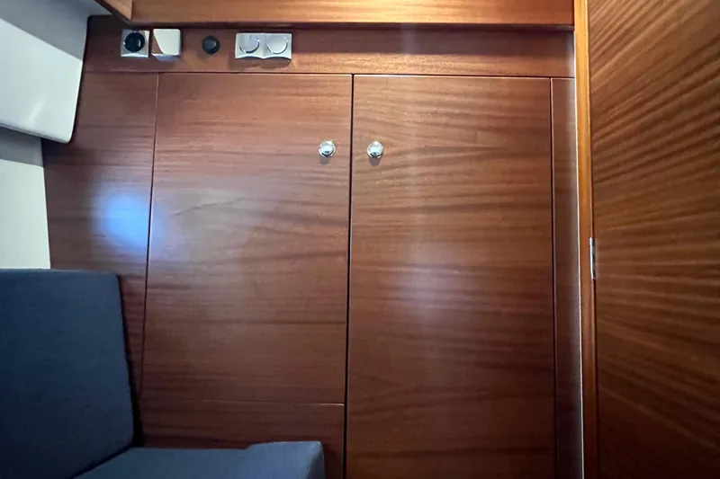 Slide: The Image of Wooden interior of 2018 Nimbus 365 Coupe boat with seating and storage. - 150