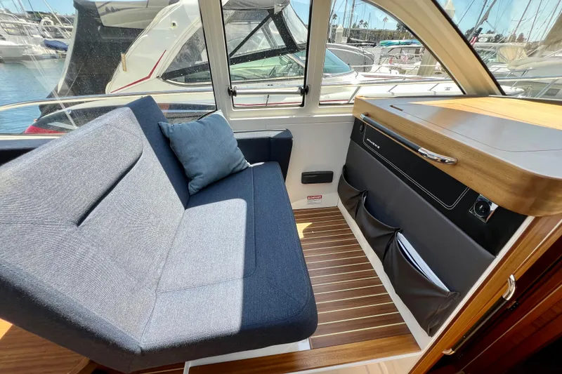 Slide: The Image of Interior of 2018 Nimbus 365 Coupe with blue seating and wooden accents. - 81