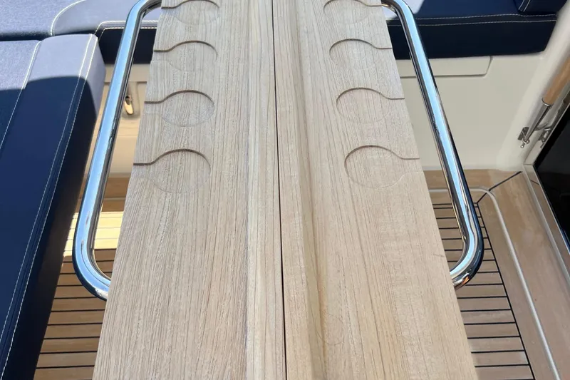 Slide: The Image of Wooden table with cup holders on a 2018 Nimbus 365 Coupe boat deck. - 48