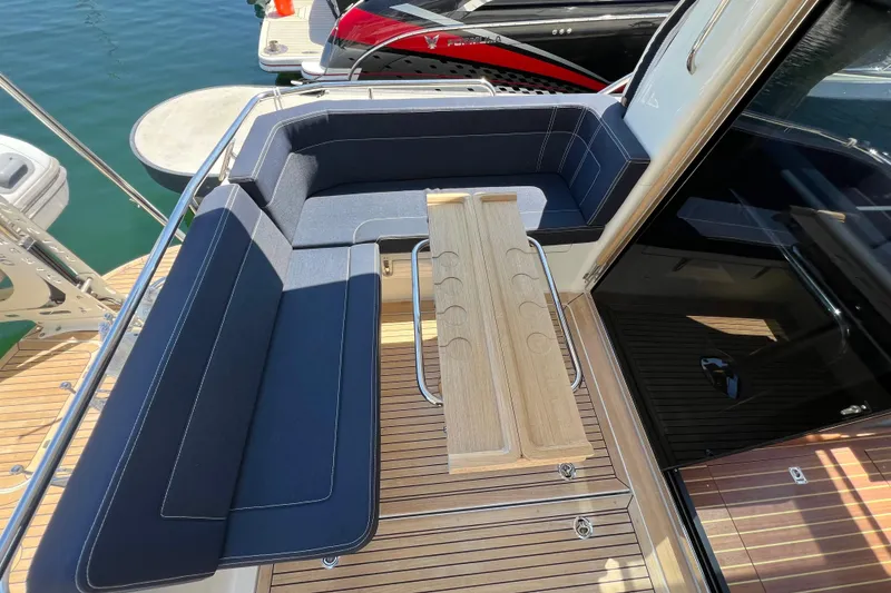 Slide: The Image of Luxurious seating area on 2018 Nimbus 365 Coupe yacht with wooden table. - 44