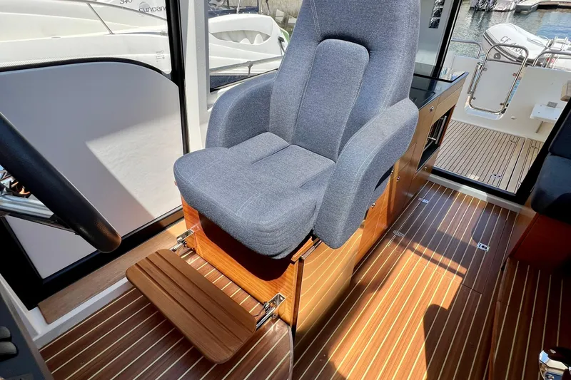 Slide: The Image of Captain's chair in 2018 Nimbus 365 Coupe, featuring sleek design and wooden flooring. - 102