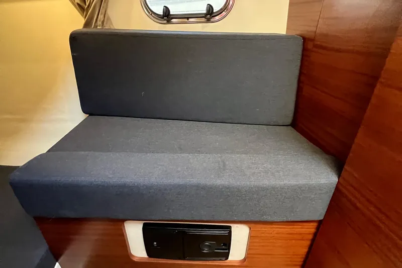 Slide: The Image of Interior seating of 2018 Nimbus 365 Coupe with gray cushions and wooden paneling. - 147