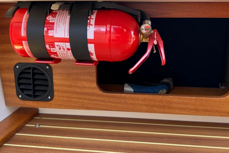 Slide: The Image of Fire extinguisher mounted on 2018 Nimbus 365 Coupe wooden interior. - 99