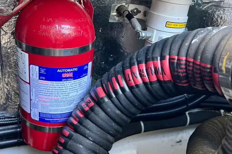 Slide: The Image of Fire extinguisher and hoses in 2018 Nimbus 365 Coupe engine compartment. - 64