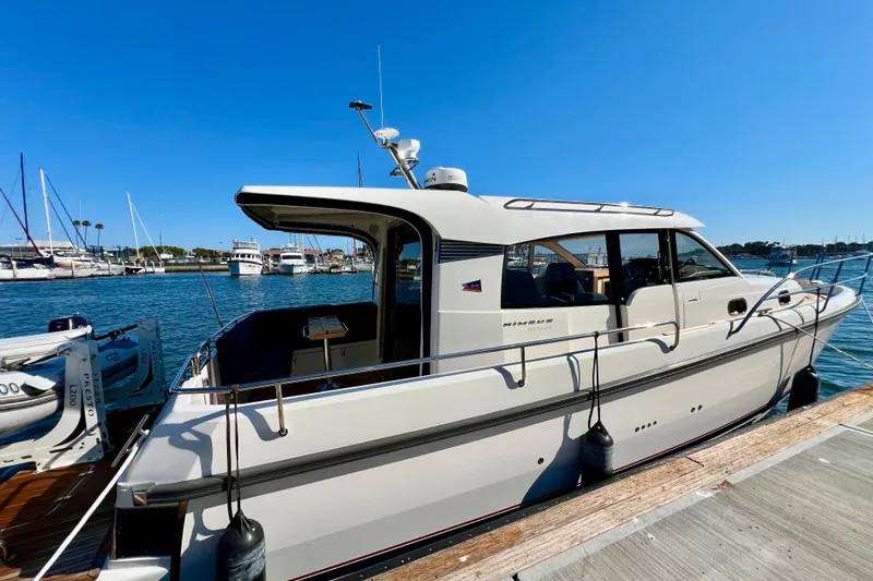 Slide: The Image of 2018 Nimbus 365 Coupe docked at marina under clear blue sky. - 11