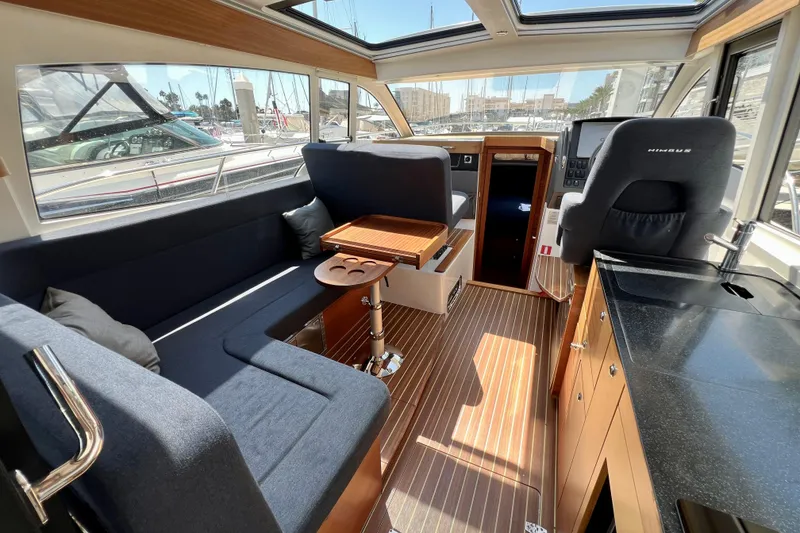 Slide: The Image of Interior of 2018 Nimbus 365 Coupe yacht with seating, table, and helm station. - 79