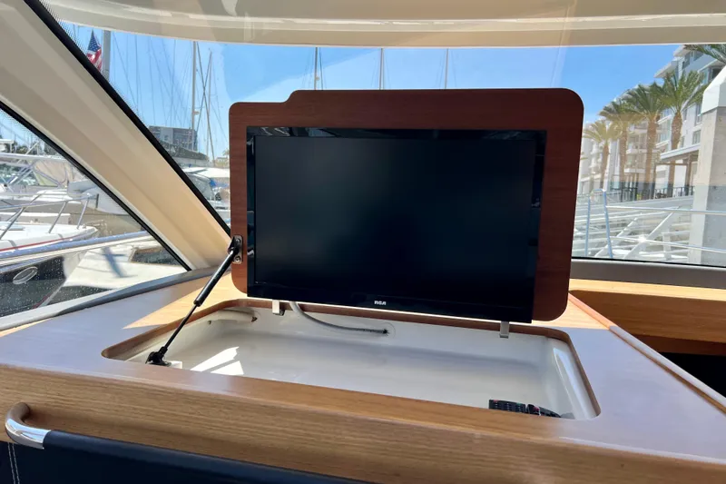 Slide: The Image of Flat-screen TV on 2018 Nimbus 365 Coupe yacht, docked with marina view. - 86