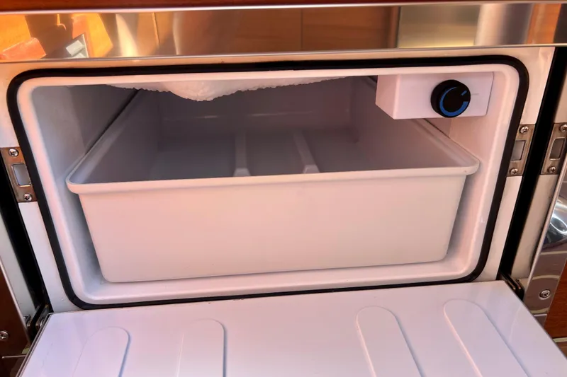 Slide: The Image of Open freezer compartment in 2018 Nimbus 365 Coupe boat kitchen. - 121
