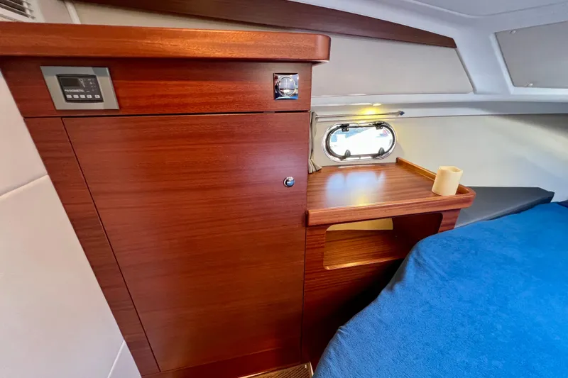 Slide: The Image of Interior of 2018 Nimbus 365 Coupe with wooden cabinetry and cozy sleeping area. - 133