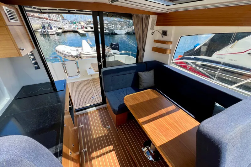 Slide: The Image of Interior of 2018 Nimbus 365 Coupe yacht with wooden flooring and marina view. - 70