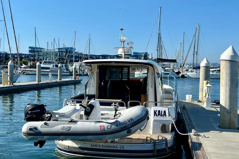 Slide: The Image of 2018 Nimbus 365 Coupe docked at marina, Santa Barbara, with inflatable boat attached. - 18