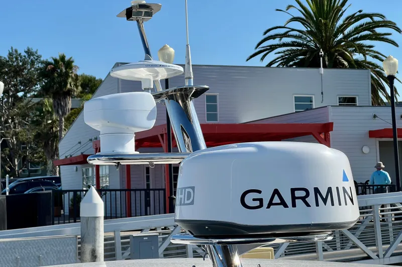 Slide: The Image of Garmin radar on 2018 Nimbus 365 Coupe boat, docked near palm trees and buildings. - 31
