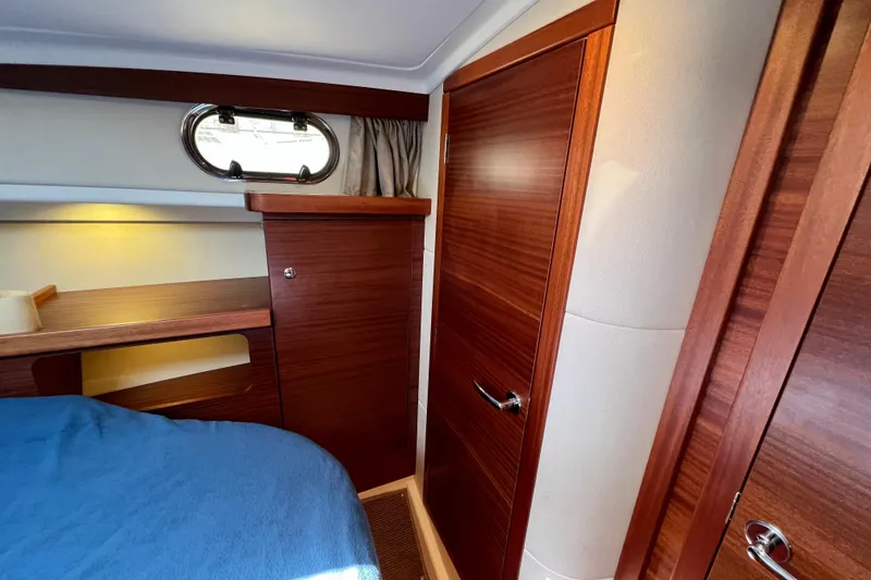 Slide: The Image of Interior cabin of 2018 Nimbus 365 Coupe with wooden finish and porthole window. - 136