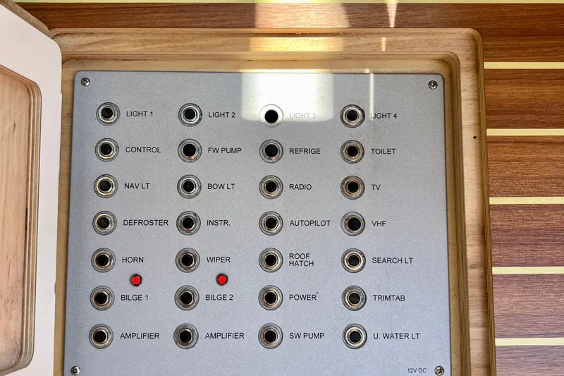 Slide: The Image of Control panel of a 2018 Nimbus 365 Coupe boat with labeled switches and indicators. - 123
