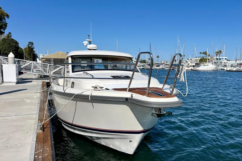 Slide: The Image of 2018 Nimbus 365 Coupe docked at marina, clear blue sky, calm water. - 4