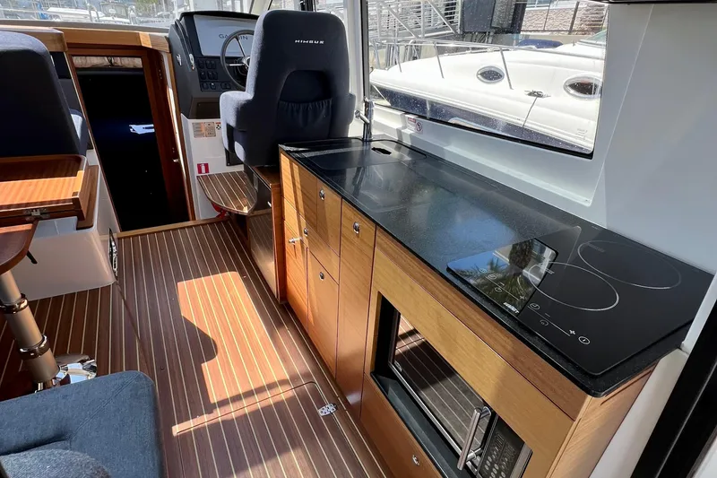 Slide: The Image of Interior of 2018 Nimbus 365 Coupe with modern kitchen and steering area. - 88