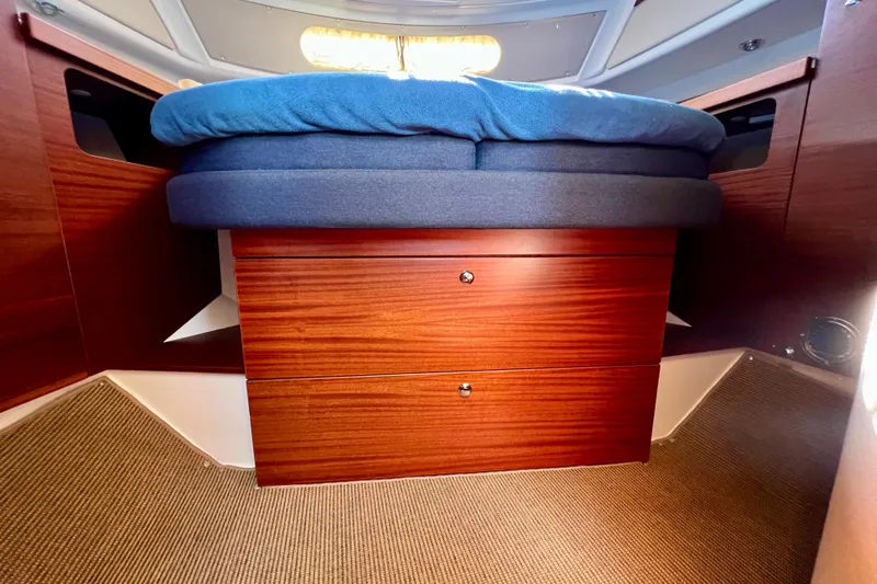 Slide: The Image of Interior of 2018 Nimbus 365 Coupe with wooden drawers and blue cushioned bed. - 132