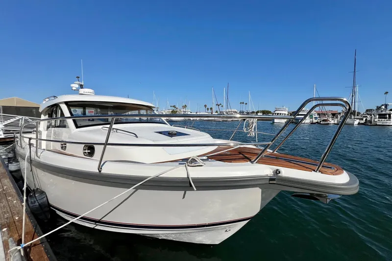 Slide: The Image of 2018 Nimbus 365 Coupe docked at marina under clear blue sky. - 5