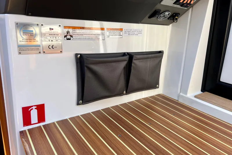 Slide: The Image of Interior of 2018 Nimbus 365 Coupe with safety labels and storage pouches. - 98