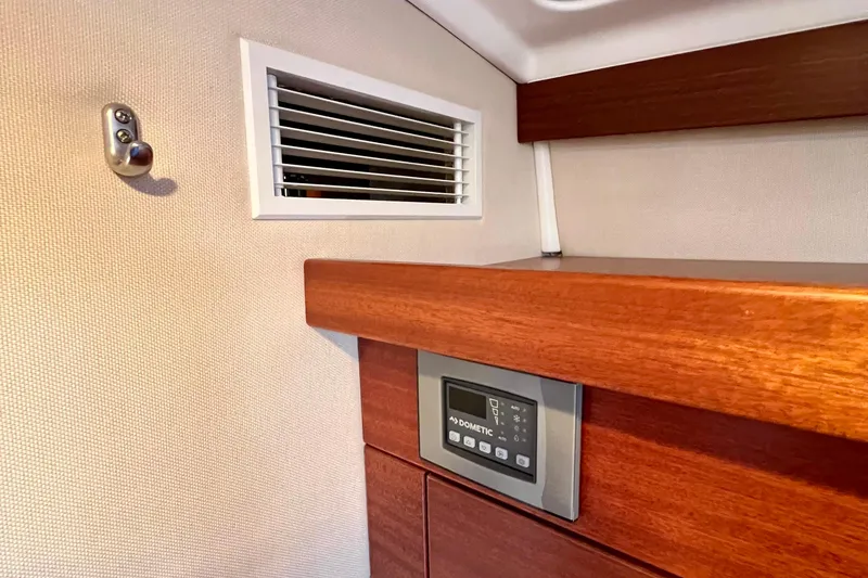 Slide: The Image of Interior of 2018 Nimbus 365 Coupe featuring wooden paneling and a Dometic control panel. - 135